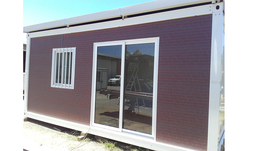 Prefab container with exterior wall cladding